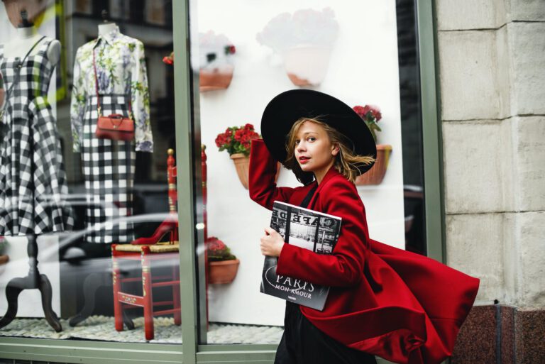 woman in red coat holding book