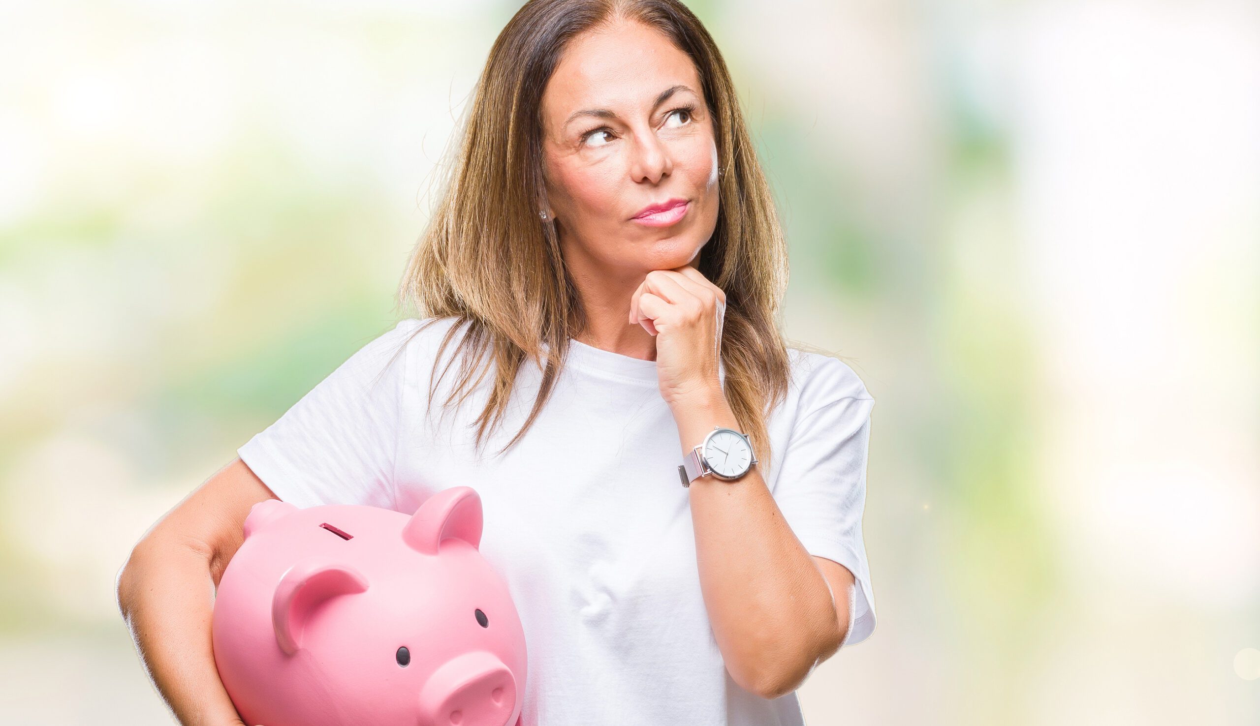 Mature-woman-carrying-piggybank-saving-money